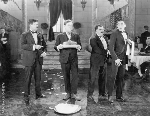 Restaurant with two managers and two waiters and broken plates 