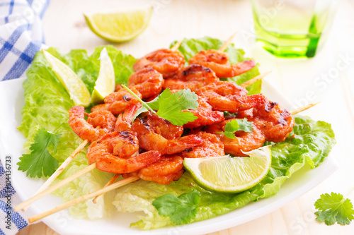 Delicious shrimp on skewers with barbecue sauce.