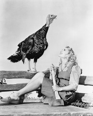Live turkey and woman with axe 