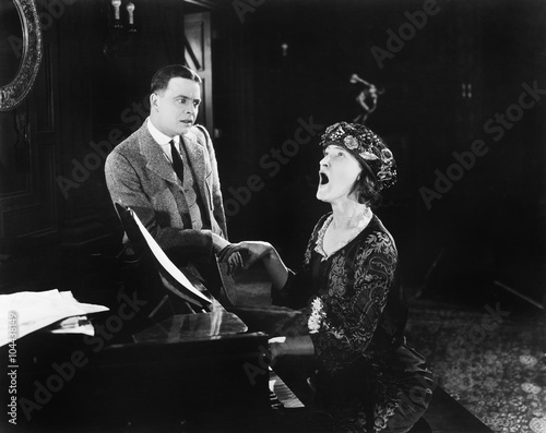 Картината върху платно Man looking in horror at a singing woman