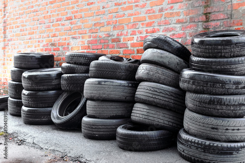 used tires at the brick wall background