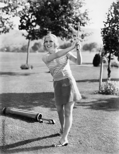 Woman playing golf on a golf course  photo