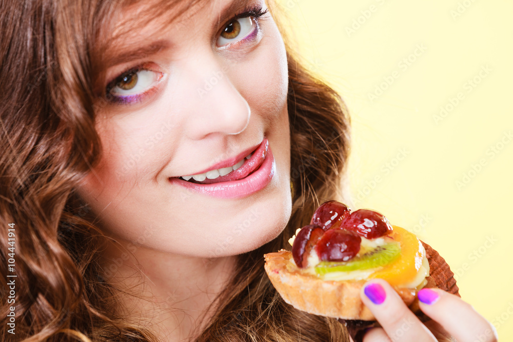 Closeup funny woman eating fruit cake Closeup funny woman eating fruit cake