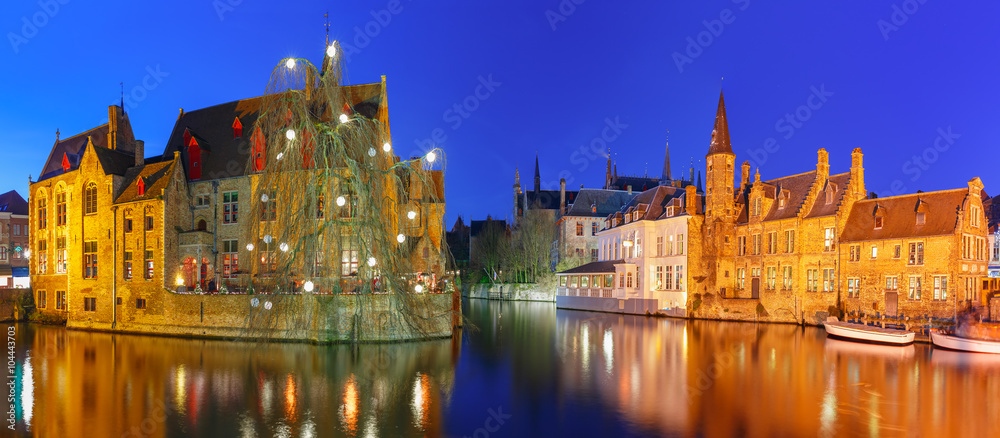 Scenic panorama with medieval fairytale town and tower Belfort from the quay Rosary, Rozenhoedkaai, at night, Bruges, Belgium