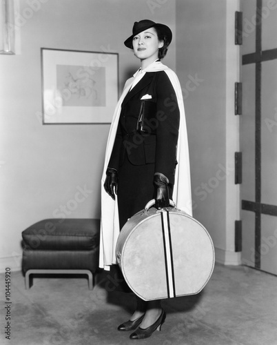 Portrait of woman carrying hatbox  photo