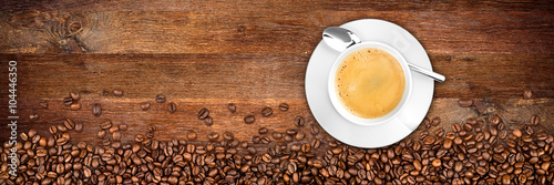 coffee background with beans and cup on rustic old oak wood