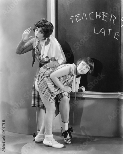 Fotografija Teacher spanking a girl in a classroom