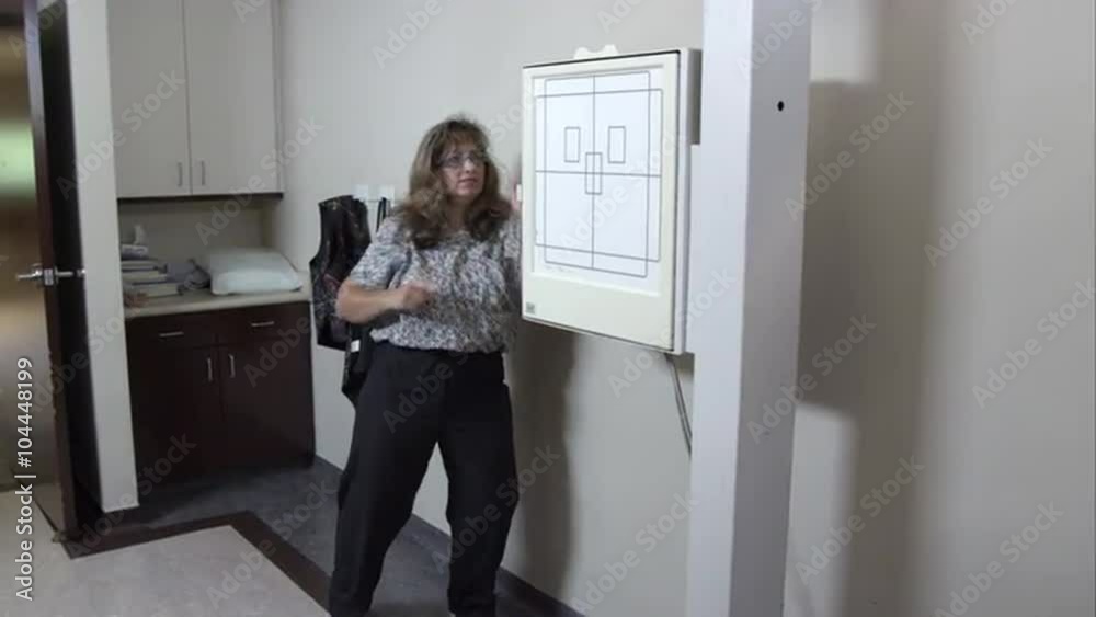 Nurse preparing equipment for scan. Nurse preparing equipment for scan.