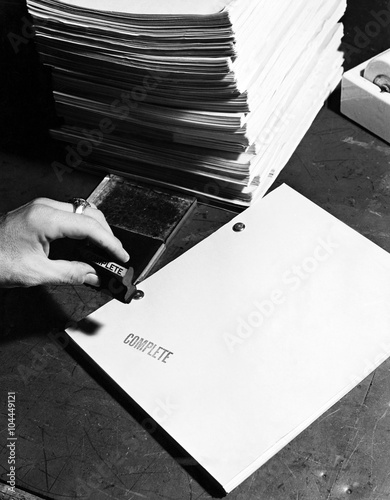 Closeup of hand stamping movie script 