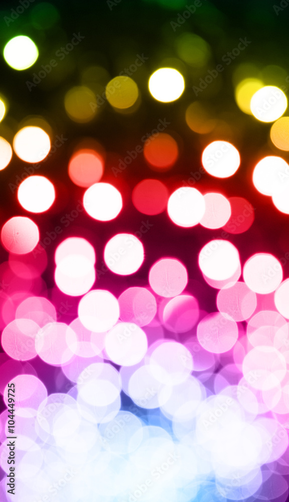 Colorful vertical ray bokeh glitter defocused lights abstract background.
