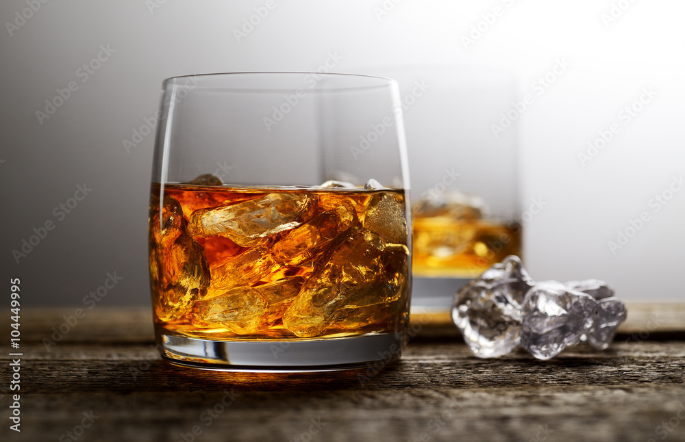 whiskey with ice on a wooden background whiskey with ice on a wooden background