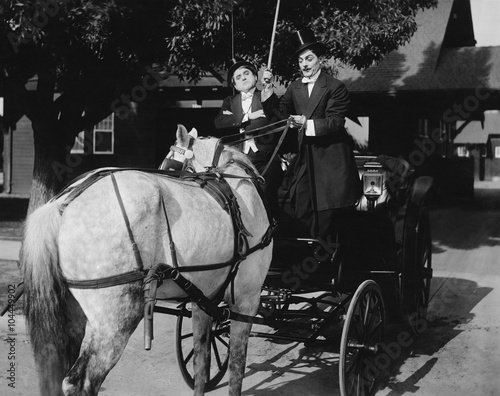 Gentlemen driving carriage with horse hitched backwards  photo