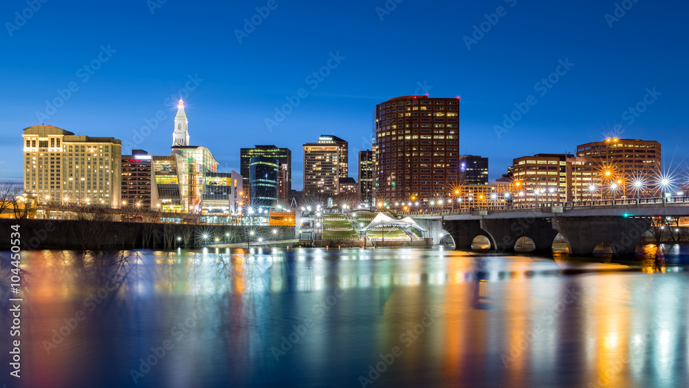 Hartford skyline and Founders Bridge at dusk. Hartford is the capital of Connecticut.
