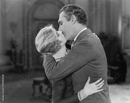 Canvas Print Couple embraced and kissing each other