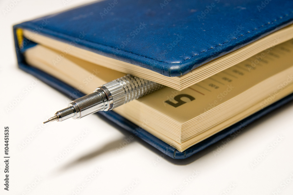 Blue diary and mechanical pencil within Blue diary and mechanical pencil within