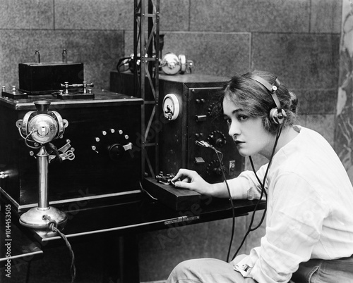 Woman sending Morse code using telegraph  photo