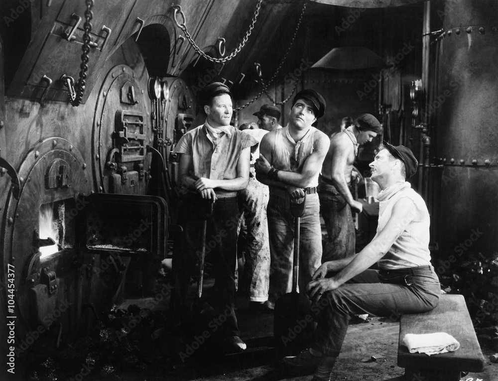 Men together in a ship's boiler room 
