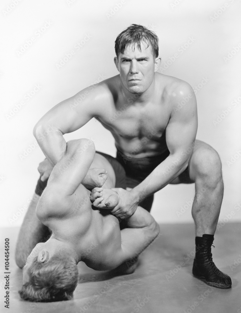 Two men wrestling with each other Two men wrestling with each other