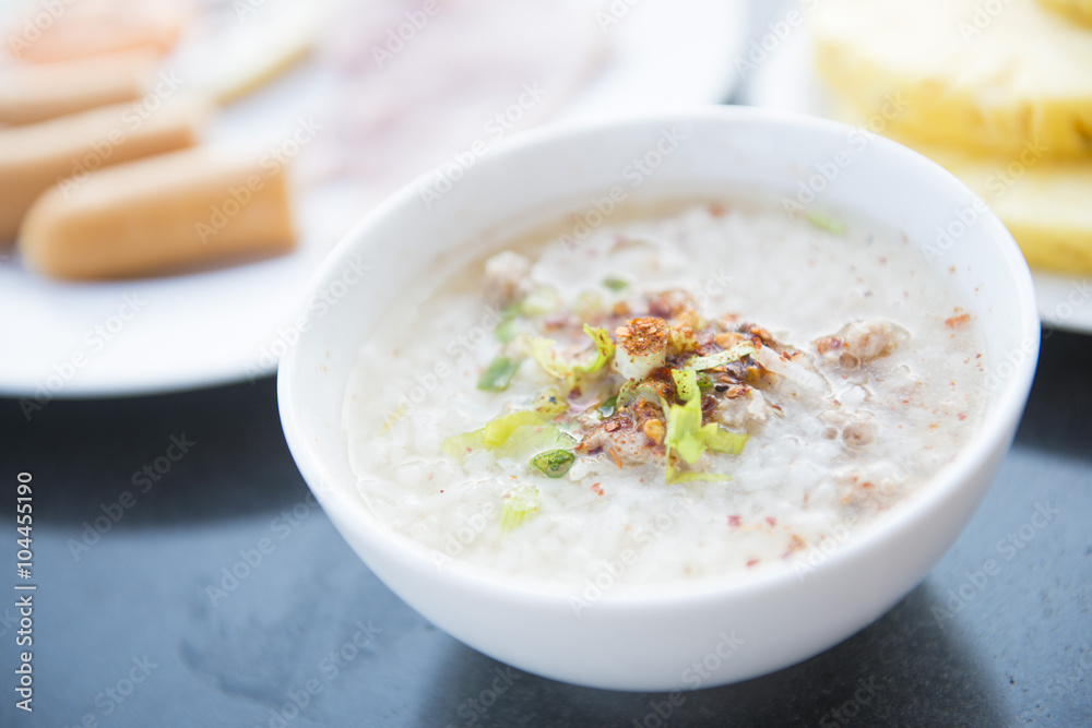 rice soup with minced pork in white bowl