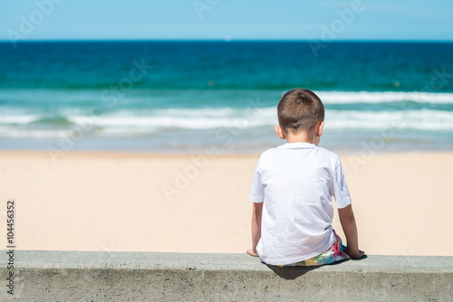 Photography Sad boy sitting at the beach