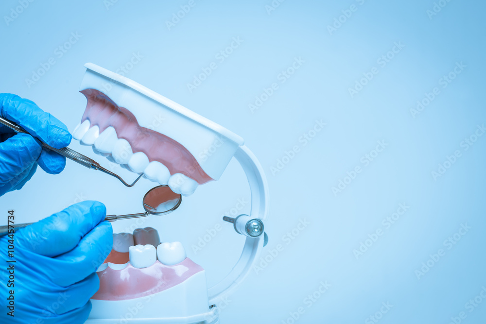 Gloved hand holding dental tools Gloved hand holding dental tools