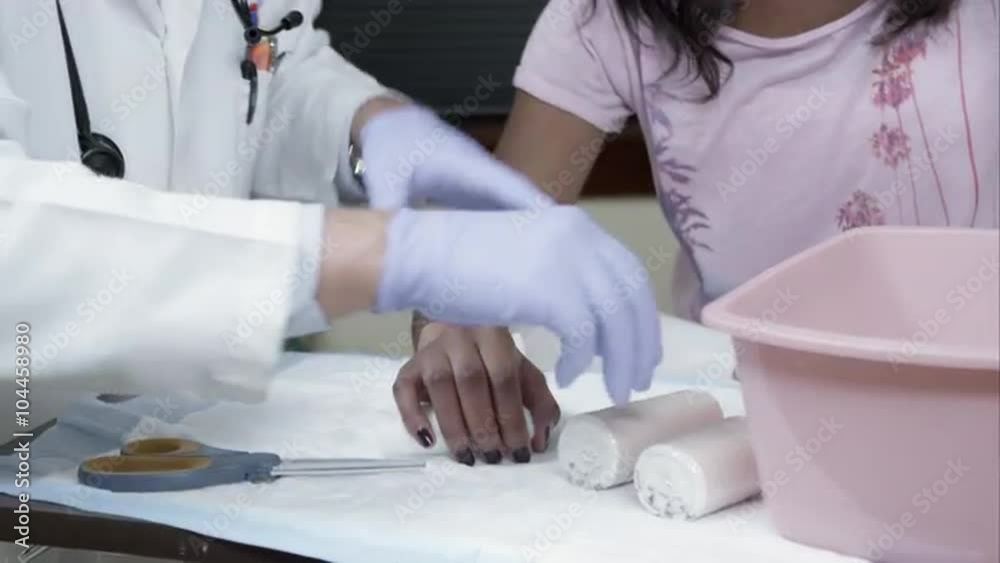 Doctor preparing to wrap woman's wrist. Doctor preparing to wrap woman's wrist.