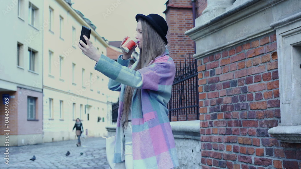 Pretty girl in pastel jacket doing selfies on smartphone and drinking coffee
Pretty girl in pastel jacket doing selfies on smartphone and drinking coffee
