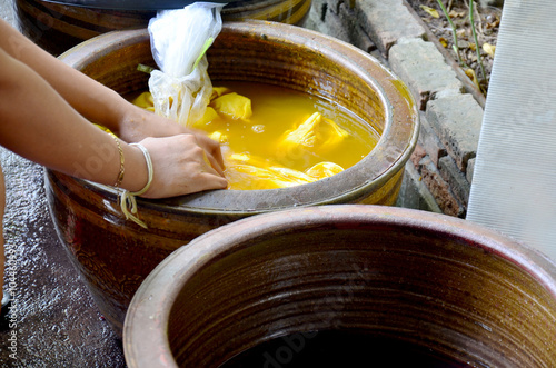 Thai women tie batik dyeing yellow natural color made from turme photo