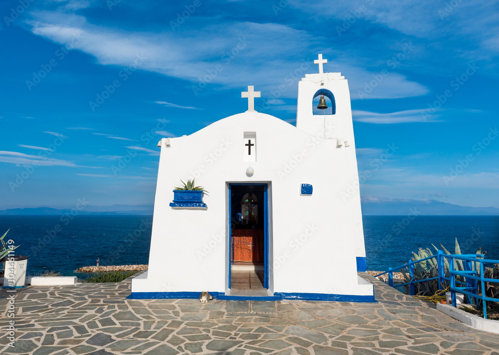 Typical greek place with a white small orthodox chapel dedicated to St. Nikolaos. Rafina, Greece