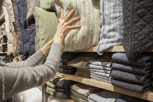 Women are choosing a cushion in the interior shop