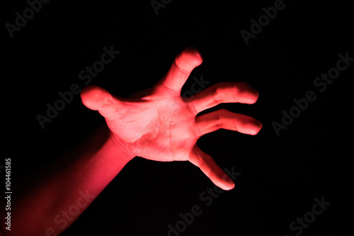 Hand Reflective red light in the dark background for scary