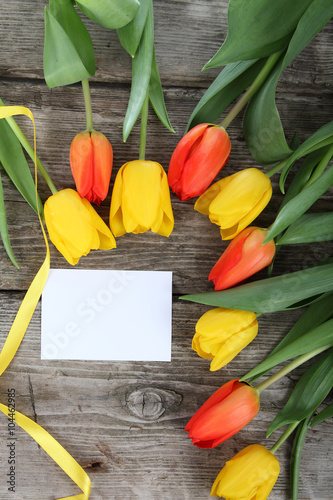 Bouquet of yellow and red tulips and card