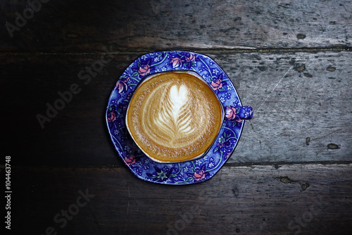 cup of latte art coffee on wooden background © nimon_t