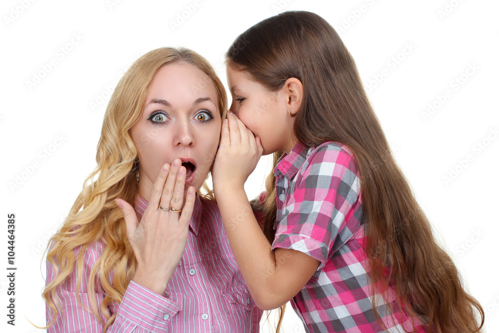 sweet and beautiful little girl tells mom something to the ear isolated on a white background sweet and beautiful little girl tells mom something to the ear isolated on a white background