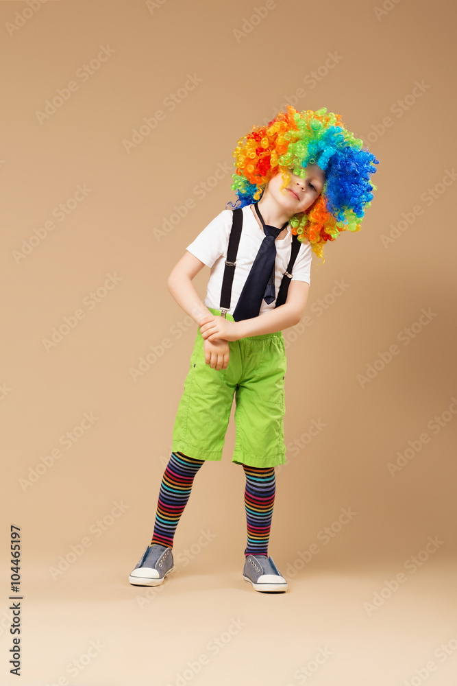 Little boy in clown wig dancing and having fun Little boy in clown wig dancing and having fun