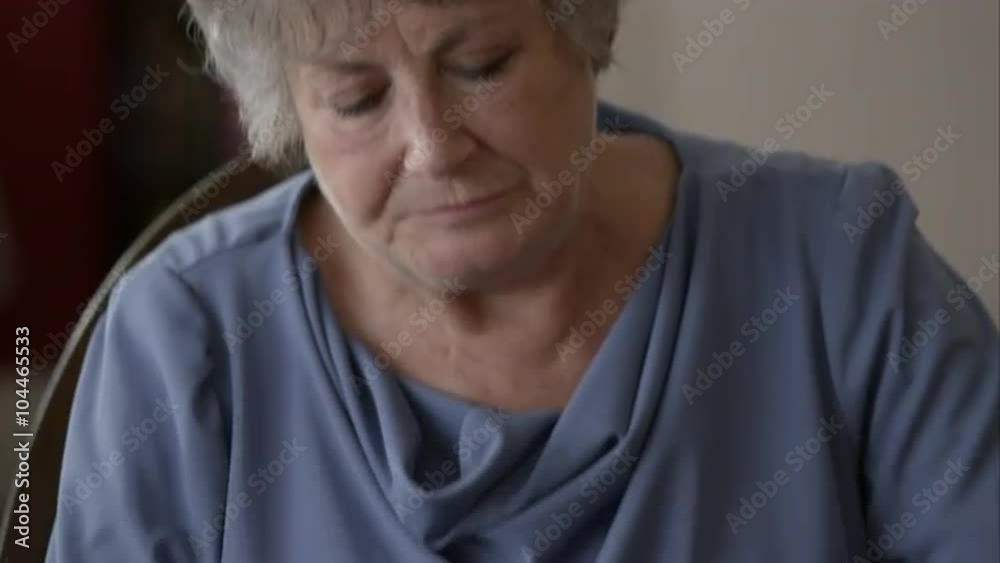 Tight shot of elderly woman eating breakfast and taking pills. Tight shot of elderly woman eating breakfast and taking pills.