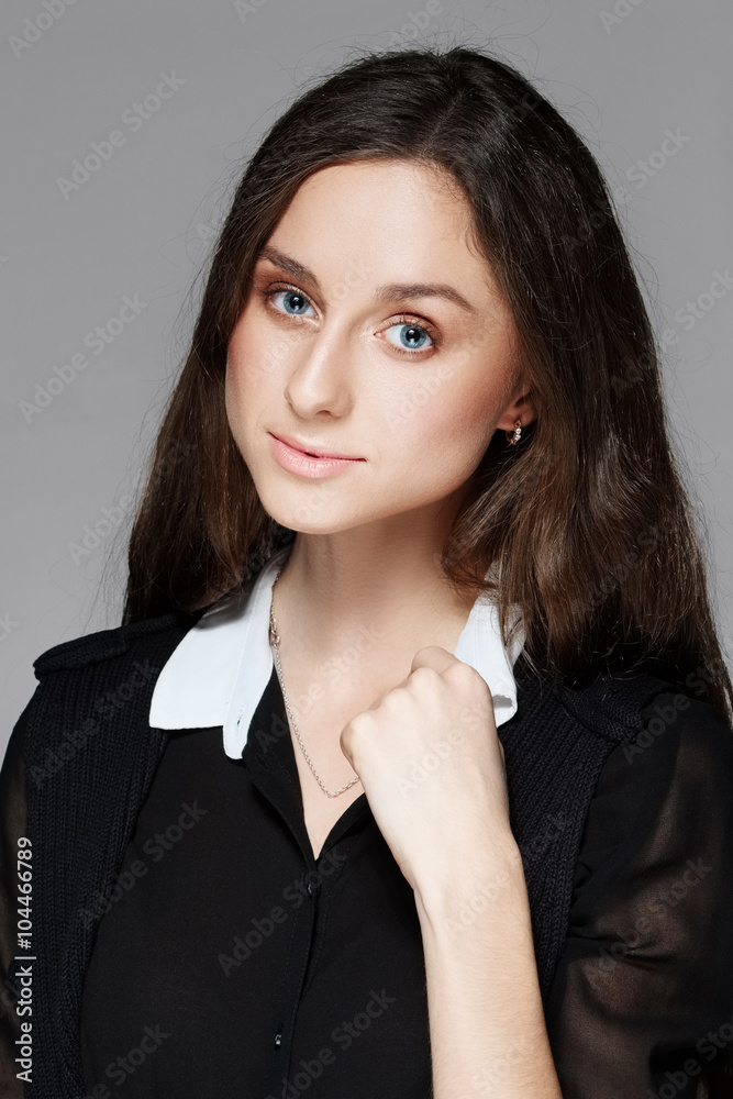 portrait of a pretty girl touching her collar portrait of a pretty girl touching her collar