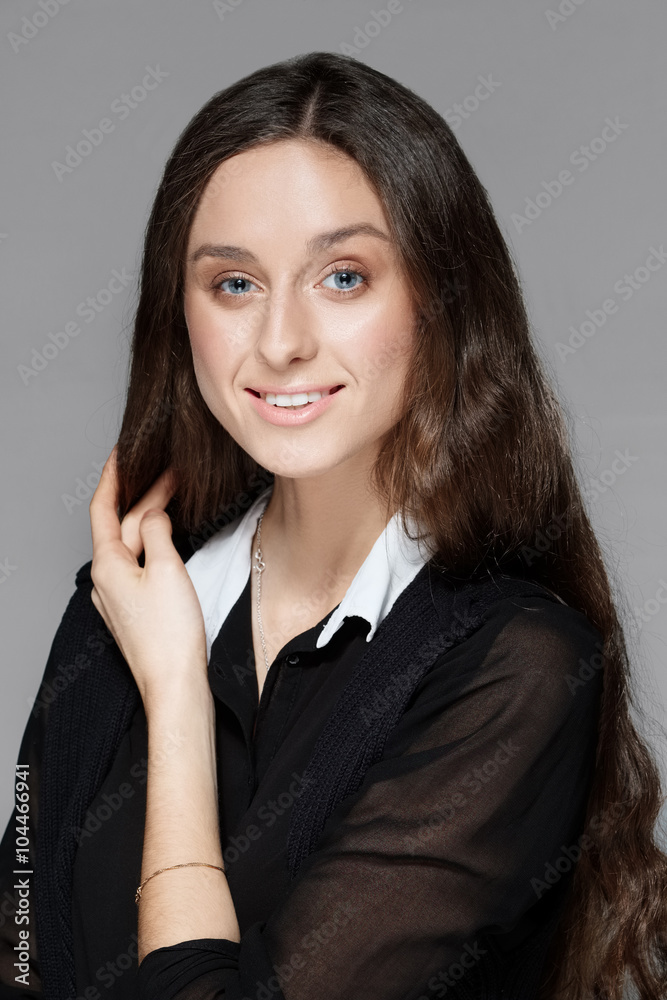 portrait of a pretty smiling girl touching her hair portrait of a pretty smiling girl touching her hair