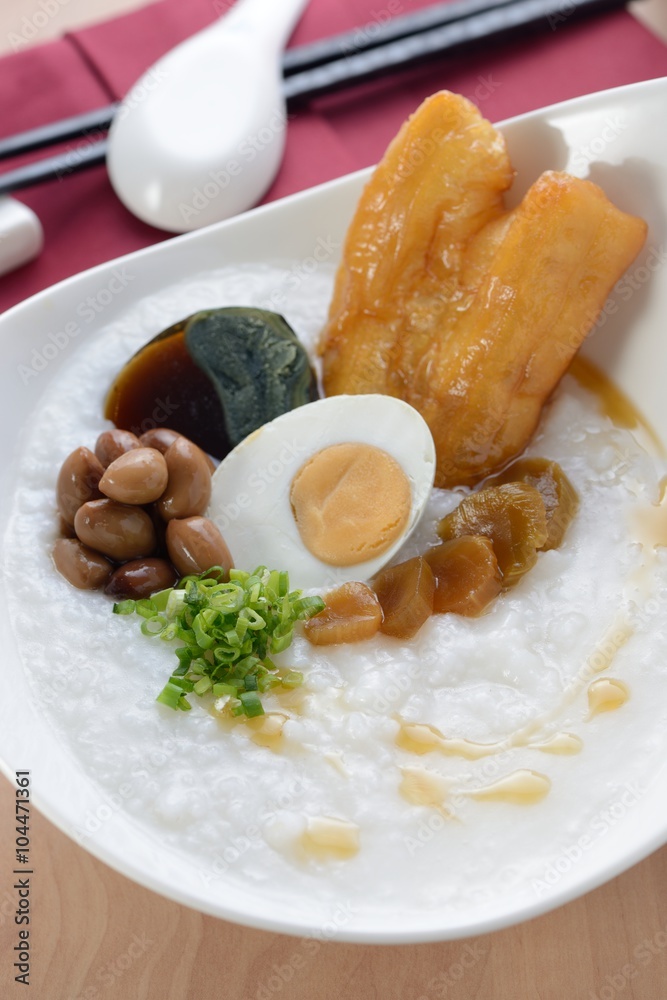Asian porridge with salted egg, peanut, deep-fried dough stick Asian porridge with salted egg, peanut, deep-fried dough stick