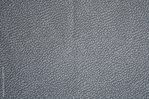 Grey fabric background with leather print close up