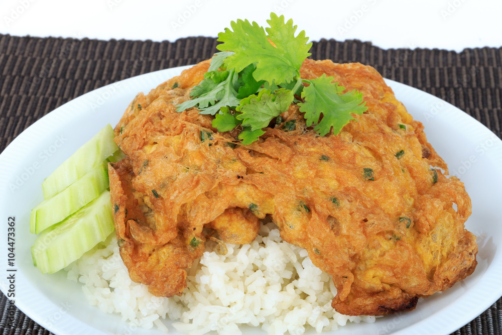 Traditional Thai style, Omelet on Thai Jasmine Rice on Brown Cloth Background. Traditional Thai style, Omelet on Thai Jasmine Rice on Brown Cloth Background.