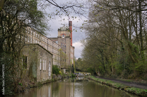 An old traditional historic mill  by the canalside depicting Britain’s Industria heritage in Bollington Cheshire U.K. photo