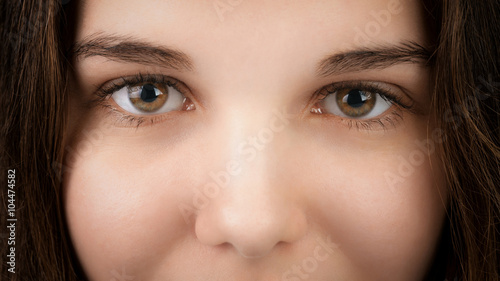 closeup portrait of young woman with hazel eyes, focus on eyes