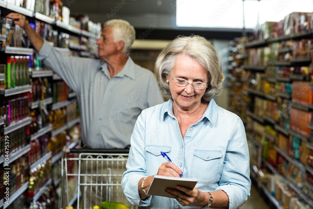 Smiling senior woman checking list
