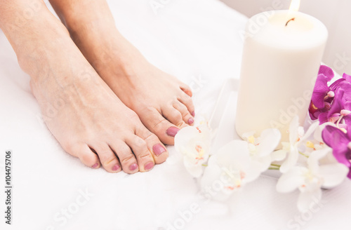 Close up of woman's feet and beauty saloon decorations