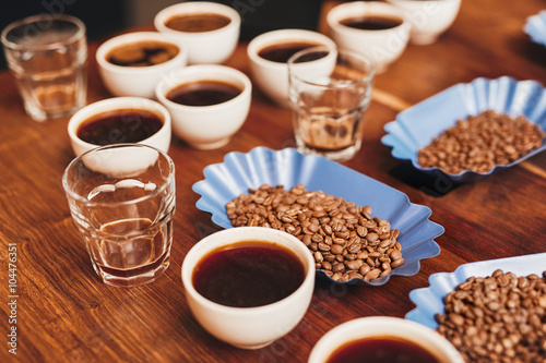 Variety of coffee in cups and beans on table