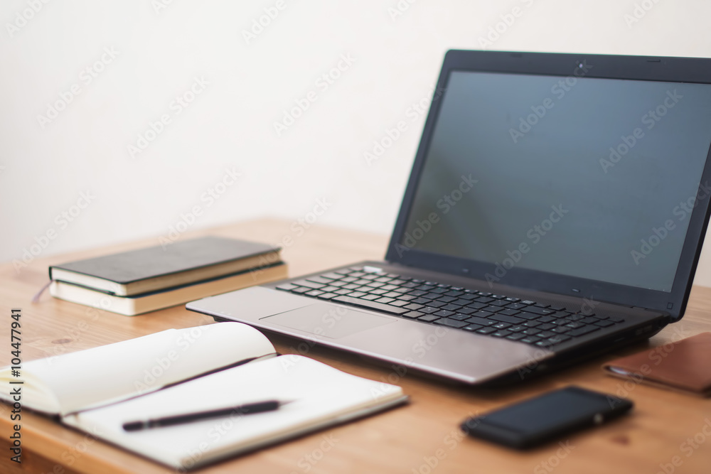 Office workplace with laptop, smart phone and notebook on wood t Office workplace with laptop, smart phone and notebook on wood t