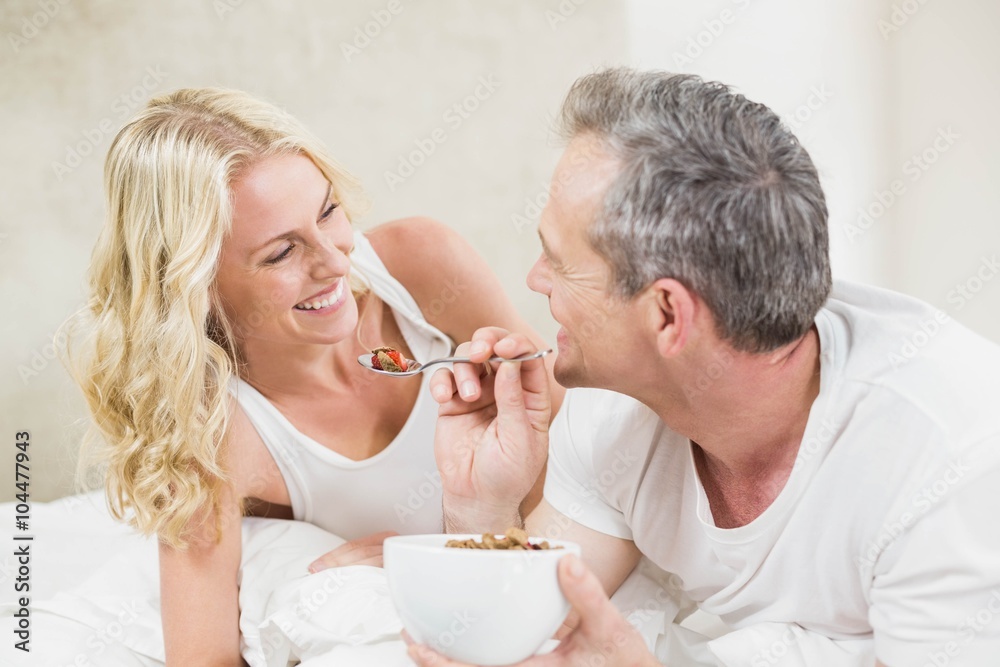 Cute couple having breakfast in bed