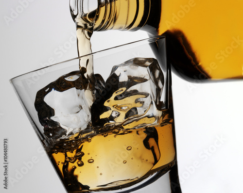 POURING GLASS OF BOURBON WHISKEY photo