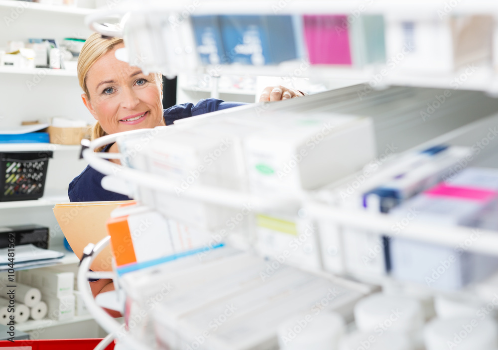 Female Chemist Counting Stock In Pharmacy Female Chemist Counting Stock In Pharmacy